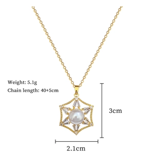 Detail of gold hexagon star pendant necklace with white pearl and rhinestone accents