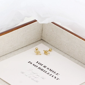 Macro shot of gold-plated S925 silver snake earrings with pavé zircon stones
