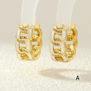 Macro shot of 18K gold plated Cuban chain earrings with white enamel and pavé zircons
