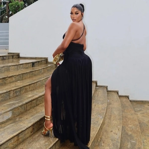 Detail of elegant black one-shoulder evening dress featuring backless cut and high side slit