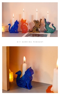 Detail of DIY cat-shaped resin candle holders with glitter in blue, orange, and black
