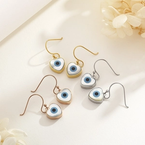 Three pairs of heart-shaped evil eye drop earrings in gold, silver, and rose gold finish