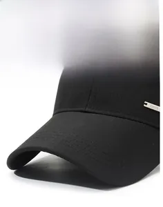 Detailed close-up of hard brim and textured fabric on black baseball cap with metal logo