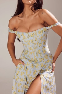 Detail of light blue floral dress with corset waist design and high side slit