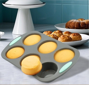 Close-up of 6-cup silicone muffin pan with muffins in a professional baking setting