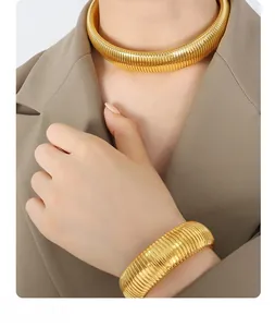 Macro shot of 18K gold plated chunky necklace and wide textured bracelet set for women