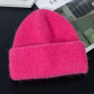 Detailed texture of thick rose red rabbit fur knit beanie with warm double-layer lining