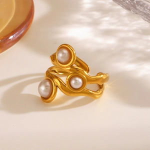 French vintage gold irregular geometric ring with three elegant pearls on a white surface