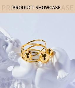 Detail of a multilayer gold-plated ring with beads on a creative sculpture prop