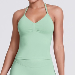 Detail of light green seamless yoga top featuring V-neck and ribbed elastic fabric