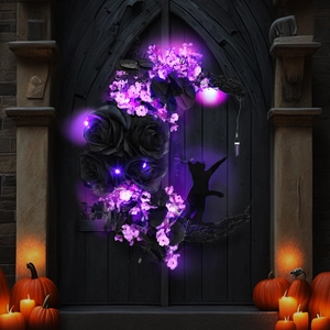 Detail of moon wreath with black roses, purple LED lights, and black cat silhouette decor