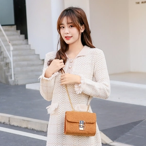 Caramel faux fur crossbody bag with gold chain strap and metal lock closure
