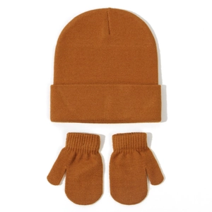 Detail of warm caramel brown knit beanie hat and ribbed cuff mittens set for winter