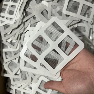 Close-up of square mesh repair stickers for screens with strong adhesive backing