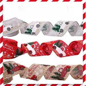 Detailed view of Christmas ribbons with vintage trucks and snowflakes on burlap fabric