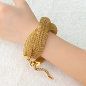 Close-up of gold mesh woven stainless steel bracelet with lobster clasp on wrist