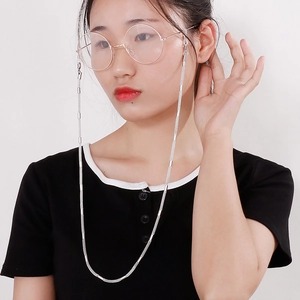 Silver stainless steel eyeglass chain with lobster clasps shown on a model