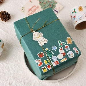 Cute Christmas stickers for gift wrapping with ginger bread man tag and gold string