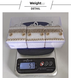 Detailed view of white faux fur foam ornaments with lace and fringe on weighing scale