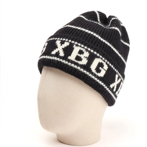 Detail showing high-quality black and white knitted texture with XBGX letter pattern