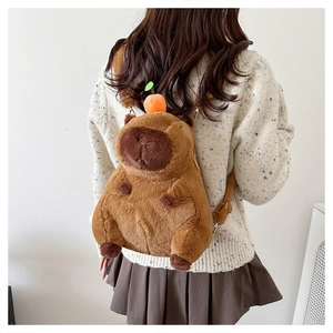 Rear view of a cute brown plush capybara backpack with a small orange on the head