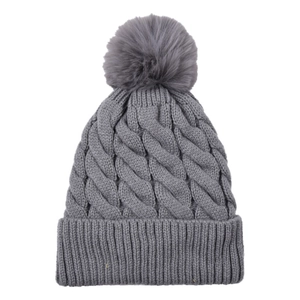 Detailed knit texture of grey acrylic winter hat featuring a fluffy faux fur pompom top