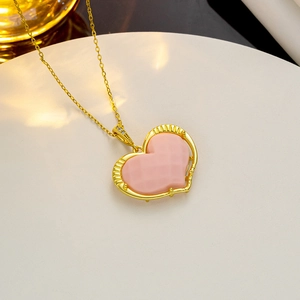 Minimalist gold necklace featuring a sweet pink heart pendant with zircon stone accents
