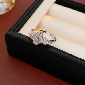 Macro detail of silver rhombus flower ring with mother of pearl and zircon inlay
