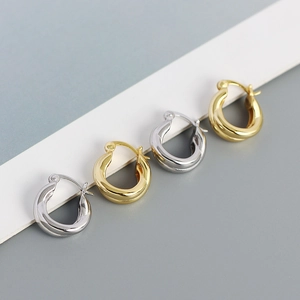 Close-up of minimalist gold and silver S925 sterling silver hoop earrings set