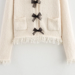 Off-white knit cardigan with black mesh bows and fringe hem detail for women