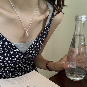 Lifestyle view of a S925 sterling silver geometric pendant necklace on a female model