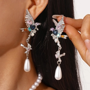 Detailed view of wing-shaped tassel earrings with colorful zircons and teardrop pearls