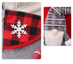 Detail of Christmas stocking featuring red plaid cuff, snowflake and grey gnome doll