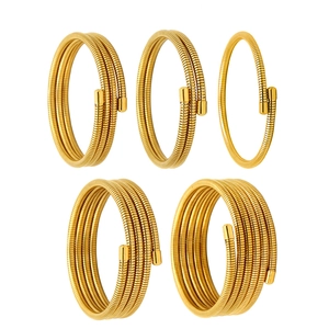 Gold spiral coil bracelets in multi-layer spring wire styles for men and women