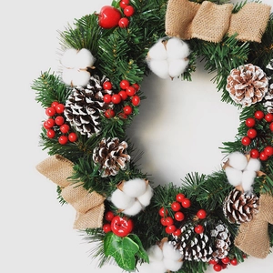 Christmas pine needle wreath with large pine cones, cotton bolls and red berries