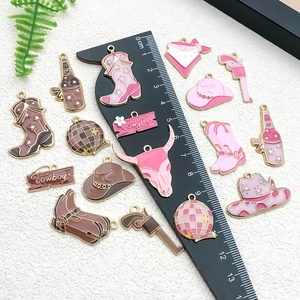 Pink and brown cowboy charms with scale ruler showing 1.5cm to 3.5cm sizing details