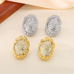 Textured oval hoop earrings with sparkling rhinestones in gold and silver finish