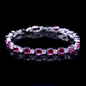 Detailed macro view of silver bracelet with square pink zircons and clear gems