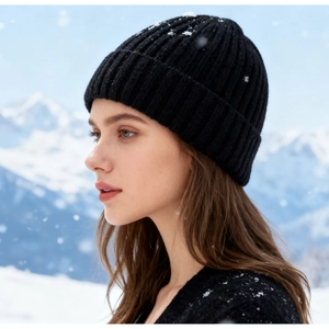 Close-up of black ribbed knit beanie for winter warmth worn in snowy outdoors