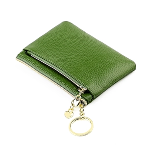 Close-up of green leather coin purse featuring a gold heart pendant and zipper closure