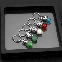 Detail shot of classic stainless steel earrings with imitation pearls in five colors