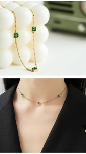 Detail of 14K gold-plated necklace featuring square emerald zircons and round bead chain
