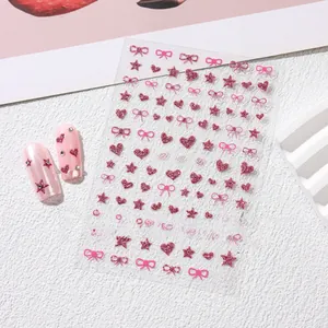 Detail showing glittery pink heart and star nail art stickers with bowknot patterns