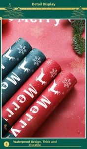 Macro shot of waterproof Christmas gift wrapping paper with reindeer patterns and water droplets