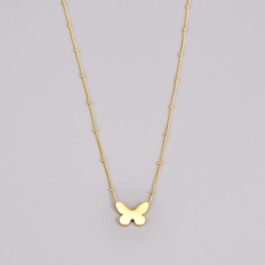 Detailed view of a golden 18K butterfly pendant necklace with a delicate satellite bead chain