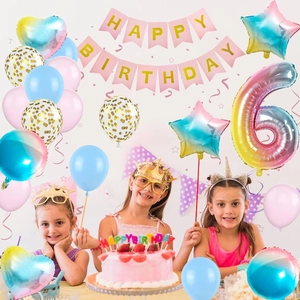 Close-up of 6th birthday decoration set with macaron balloons and rainbow foil number 6
