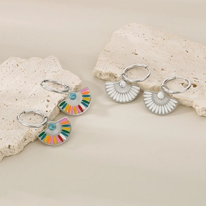 Detailed shot of fan-shaped hoop earrings with colorful enamel and turquoise beads