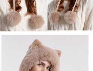 Detail of plush cat ear hat with thick faux fur pom-poms and long tassels in khaki