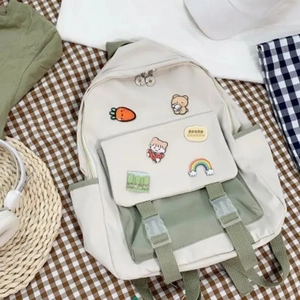 Detail of school backpack with cute badges on checkered background and campus props