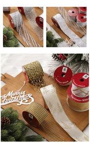 Detail of multi-style Christmas ribbons with tree patterns and mesh textures on wooden tray
